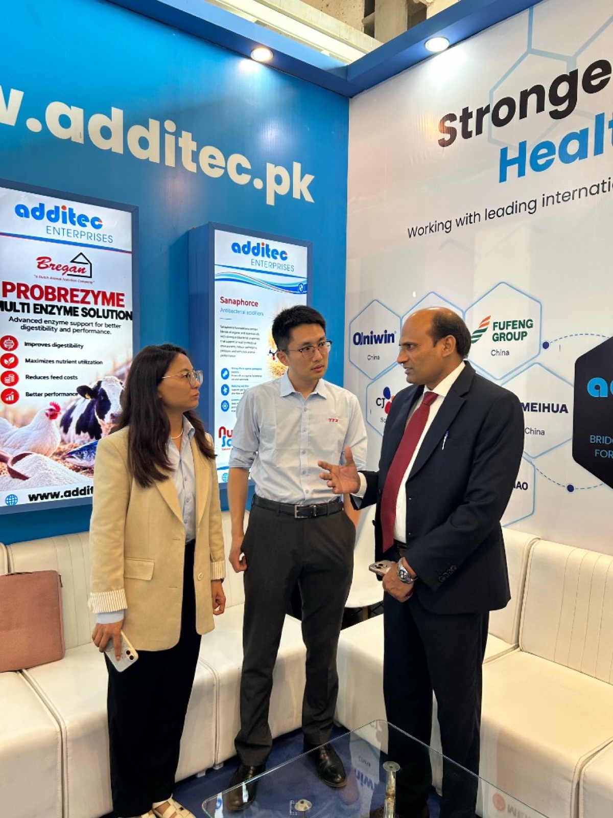 Industry professionals meeting at the Additec Enterprises exhibition stand
