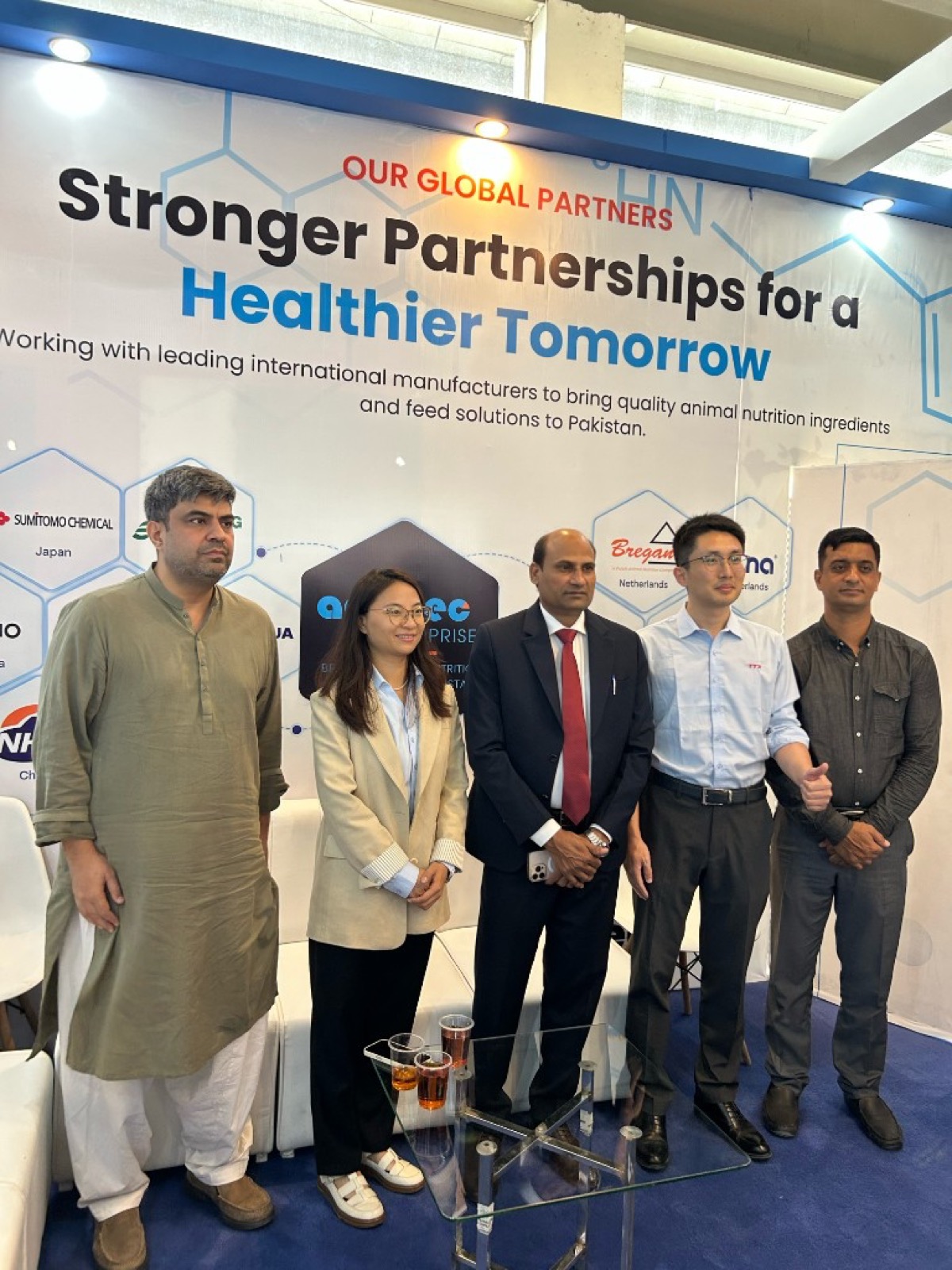 Visitors standing in front of Additec global partners backdrop at IPEX EXPO 2026