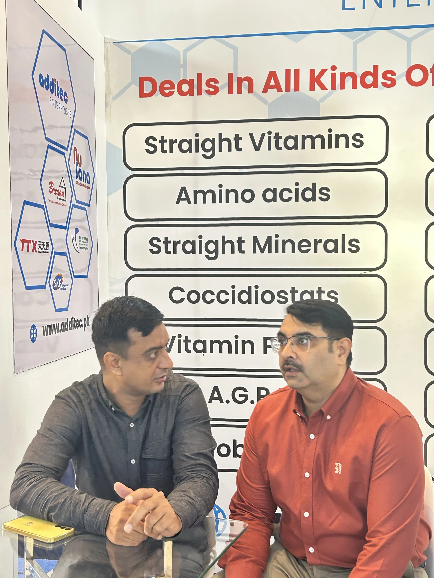 Two visitors in discussion at the Additec booth category boards during IPEX EXPO 2026 Day 01