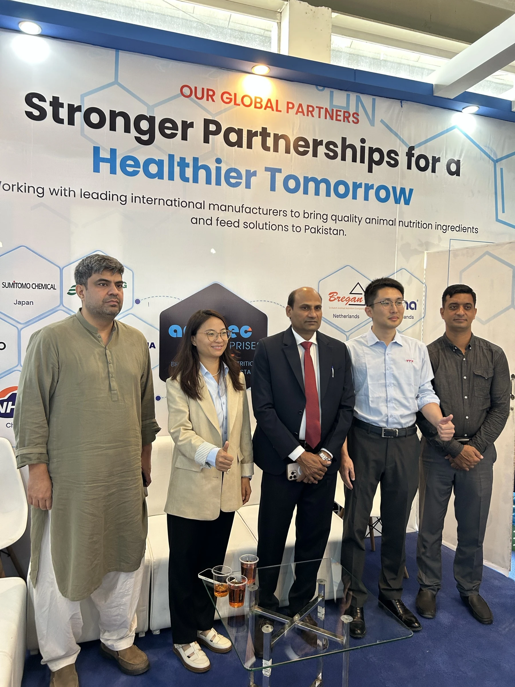 Group photograph in front of the Additec global partners backdrop at IPEX EXPO 2026