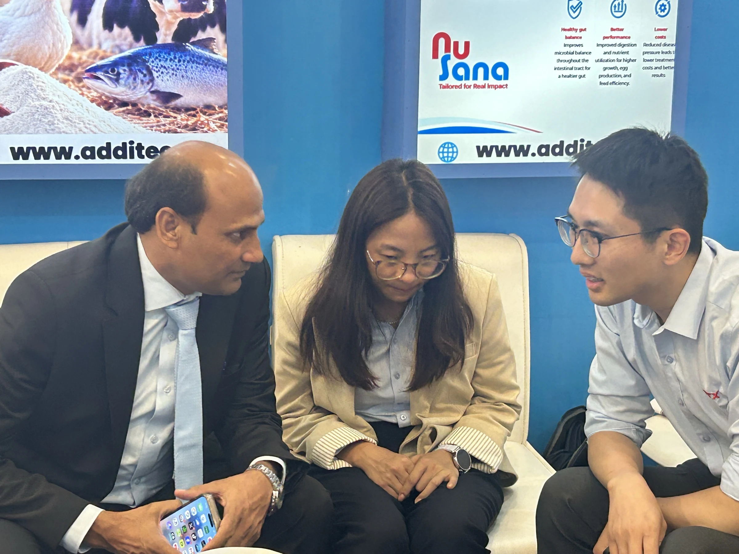 Three-person product discussion at the Additec booth during IPEX EXPO 2026 Day 02
