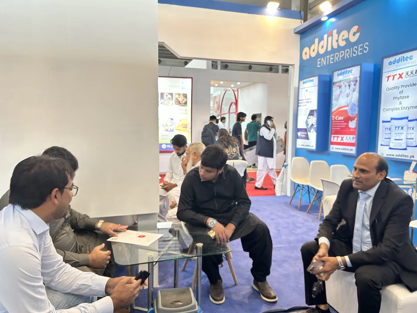 Industry professionals meeting at the Additec Enterprises exhibition stall