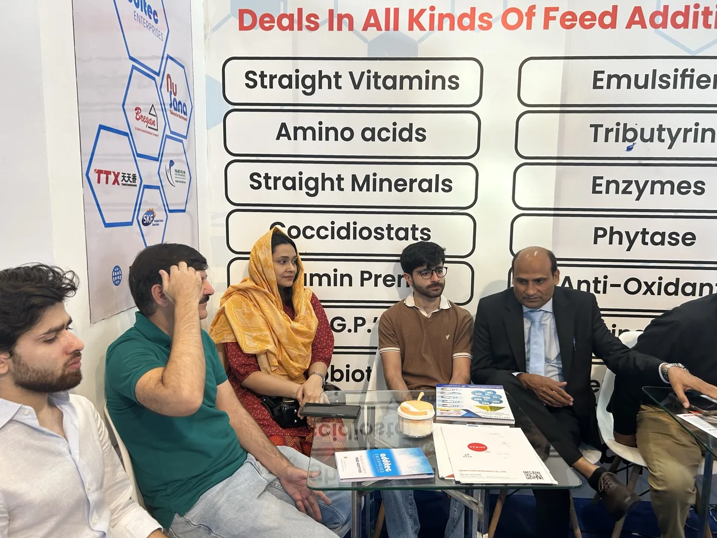 Visitors reviewing Additec feed additive category boards at IPEX EXPO 2026